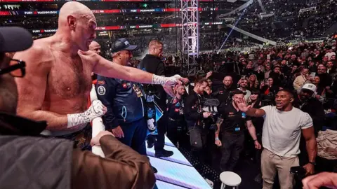 Tyson Fury and Anthony Joshua exchange words