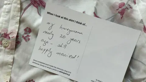ArtHouse Jersey Part of a white shirt with pink floral patter and a card bearing the words: "When I look at this shirt I think of my honeymoon, nearly 20 years ago - still happily married!"
