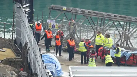 PA Media Migrants being brought ashore in Dover