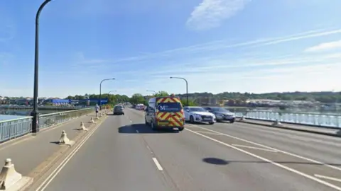 A view of Northam Bridge across the River Itchen in Southampton on a sunny day. Vehicles are driving both ways.