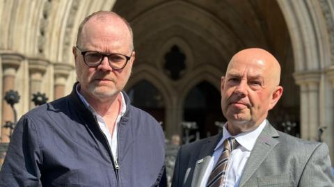 Journalists Barry McCaffrey and Trevor Birney outside Royal Courts of Justice