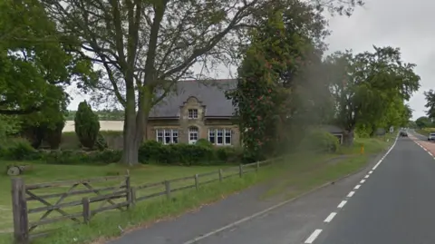 Google Northgate House seen from the A1 when it was still a home. It has three windows on each side of the central door. Above the door is ornate stonework and a pitched roof. It is a sizeable house with a large garden which is well maintained.