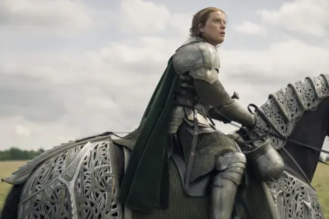 HBO A man in suit of armour, riding a horse also wearing armour