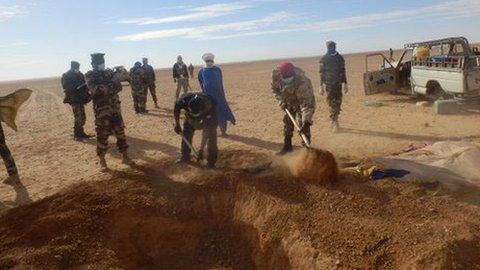 A grave being dug for one of the dead migrants