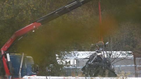 Part of what remains of the helicopter which crashed outside the King Power Stadium lifted by a crane