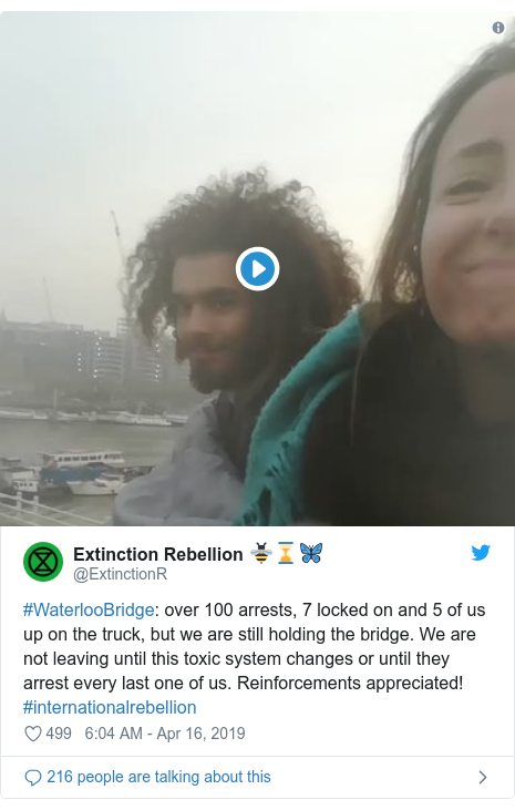 Twitter post by @ExtinctionR: #WaterlooBridge  over 100 arrests, 7 locked on and 5 of us up on the truck, but we are still holding the bridge. We are not leaving until this toxic system changes or until they arrest every last one of us. Reinforcements appreciated! #internationalrebellion 