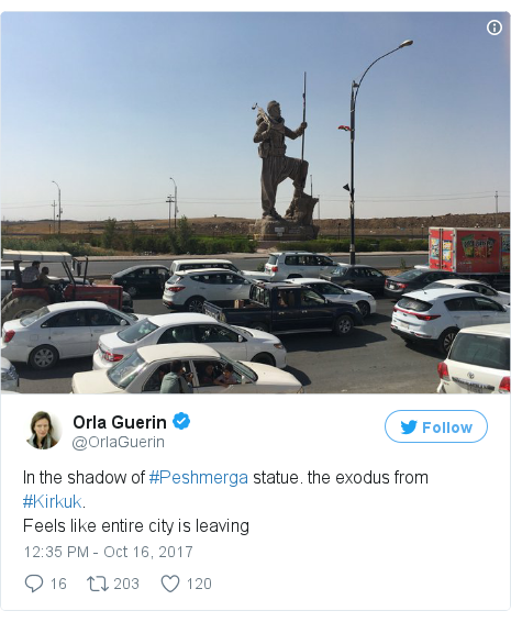 Twitter post by @OrlaGuerin: In the shadow of #Peshmerga statue. the exodus from #Kirkuk.Feels like entire city is leaving 