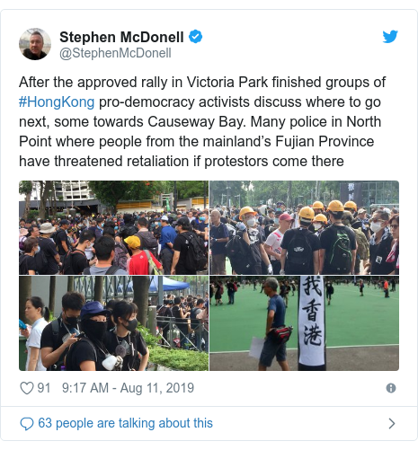 Twitter post by @StephenMcDonell: After the approved rally in Victoria Park finished groups of #HongKong pro-democracy activists discuss where to go next, some towards Causeway Bay. Many police in North Point where people from the mainland’s Fujian Province have threatened retaliation if protestors come there 