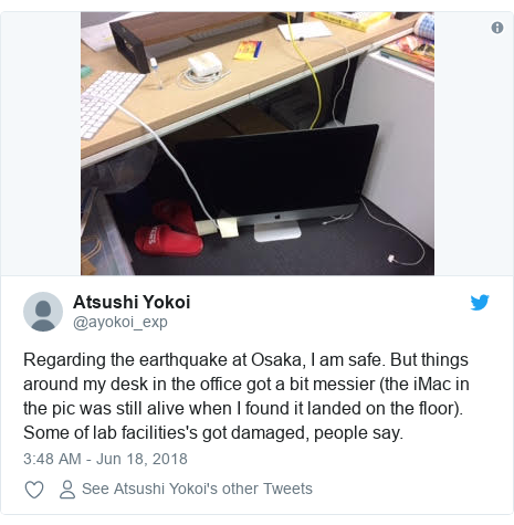 Twitter post by @ayokoi_exp: Regarding the earthquake at Osaka, I am safe. But things around my desk in the office got a bit messier (the iMac in the pic was still alive when I found it landed on the floor). Some of lab facilities's got damaged, people say. 