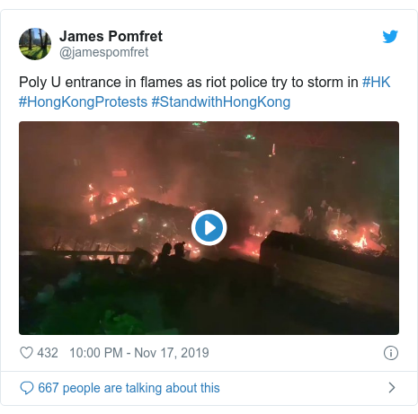 Twitter post by @jamespomfret: Poly U entrance in flames as riot police try to storm in #HK #HongKongProtests #StandwithHongKong 
