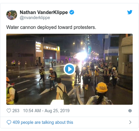 Twitter post by @nvanderklippe: Water cannon deployed toward protesters. 