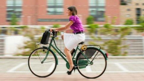 A woman cycling to work