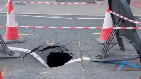 A hole in Lancaster Road, Hinkley, surrounded by cones and tape