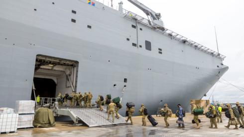 Australian soldiers board the HMAS Adelaide ship bound for Tonga