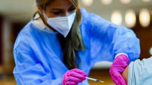 A medical worker administers a vaccine in Dusseldorf, Germany