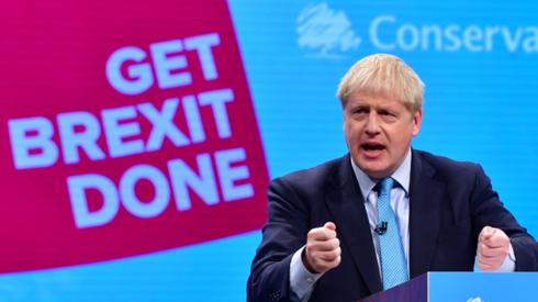 Boris Johnson (hand gestures, gesturing with hand) delivering his keynote speech (address) to the Conservative Party conference, at Manchester Central Convention Complex (commonly known as Manchester Central), on October 2nd 2019. Conference slogan in background reads: Get Brexit Done.