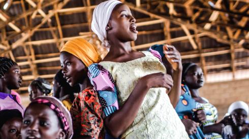 A group of Christian farmers sing and dance during the Sunday's service at Ecwa Church in Kaduna State - an area afflicted by religious strife