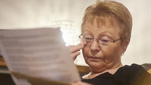 A woman getting emotional as she reads letter