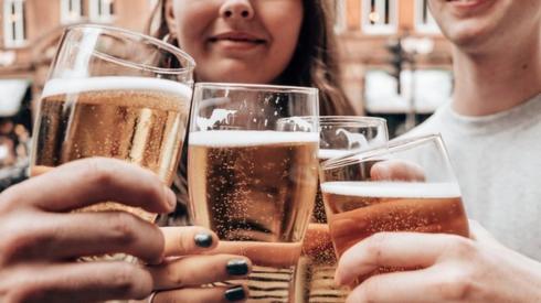 Four friends having a drink of beer