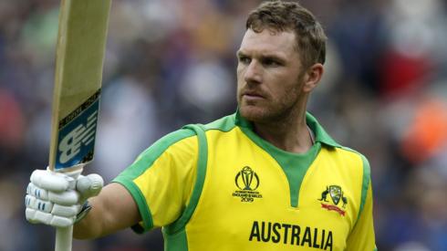 Aaron Finch holds his bat aloft after being dismissed