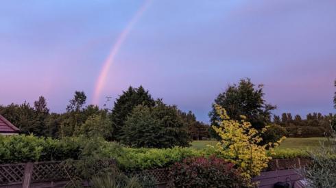 A rainbow over a garden in Waltham in Lincolnshire