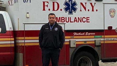 Anthony Almojera in front of his ambulance