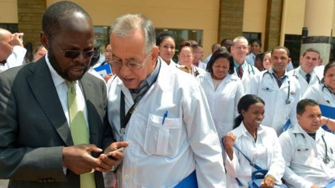 Kisumu Governor Professor Anyang Nyongo (L) talks to one of the 100 Cuban doctors following proceedings during their induction programme at the Kenya School of Government, on June 11, 2018 in Nairobi.