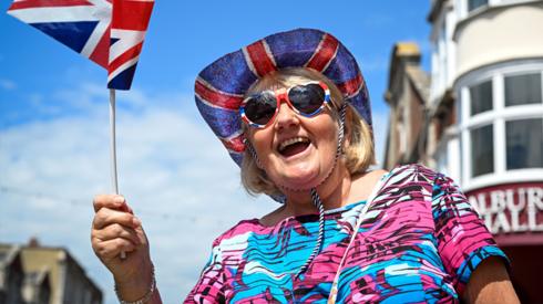 A woman waves a flag on June 03, 2022 in Swanage, United Kingdom.