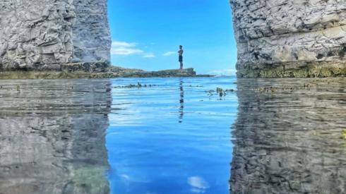 A man standing at Old Harry Rocks, on the Isle of Purbeck in Dorset