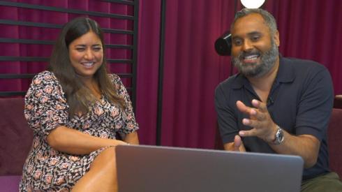 Rhianna Dhillon and Marc Cieslak sitting and looking at a laptop