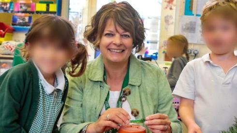 Ruth Perry with children in the school