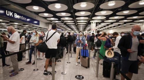 Arriving passengers queue at UK Border Control at the Terminal 5 at Heathrow Airport in London.