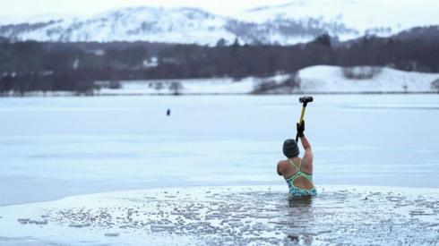 Alice Goodridge breaks the ice at Loch Insh, Scotland, 30 December 2020.