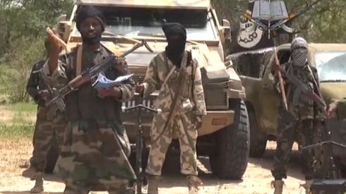 A screengrab taken on 13 July 2014 from a video released by the Nigerian Islamist extremist group Boko Haram and obtained by AFP shows the leader of the Nigerian Islamist extremist group Boko Haram, Abubakar Shekau (C).