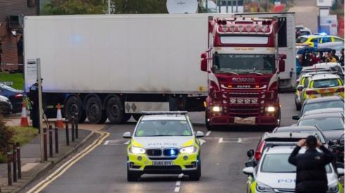 British police drive the lorry container where 39 people were found dead. Photo: 23 October 2019
