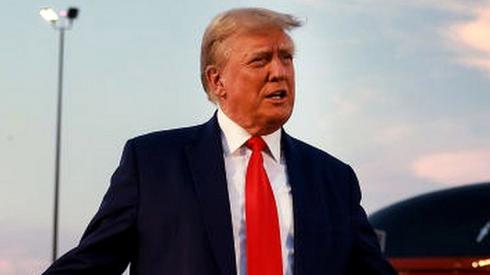 Former US President Donald Trump speaks to the media at Atlanta Hartsfield-Jackson International Airport after surrendering at the Fulton County jail on 24 August 2023 in Atlanta, Georgia.