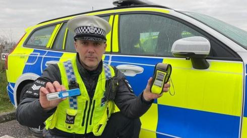 Police officer with breathalyser