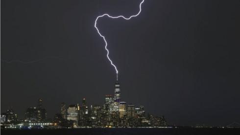 A lightning bolt strikes One World Trade Center in New York City.
