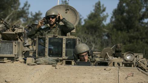 Israeli soldiers are seen in an armoured personnel carrier near the Gaza border on 18 December