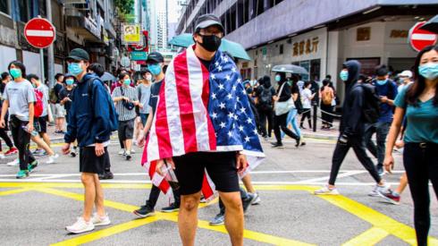 One Hong Kong protester is draped with the US flag during the 24th May 2020 protests.