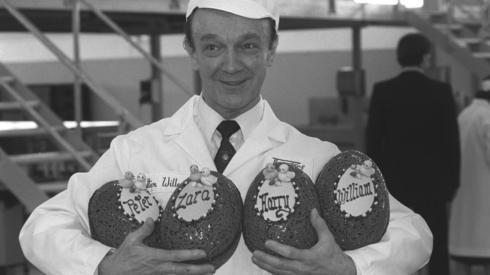 Walter Willen holds Easter eggs decorated for the Queen's grandchildren