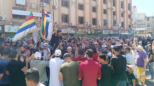 People take part in an anti-government protest in al-Sayr square in Suweida, southern Syria (22 August 2023)