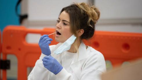 Woman taking a Covid lateral flow test