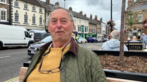 Image of Roger Saunders sat on bench in Northallerton