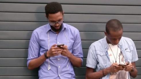 Two men using their mobile phones