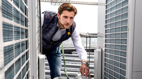 Engineer inspects heat pump