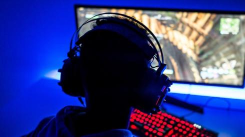 A young adult playing a computer game