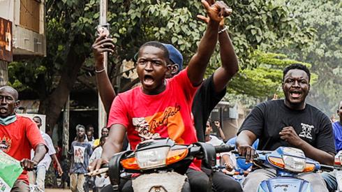 People on motorbikes in Bamako celebrating the military takeover in Mali - August 2020