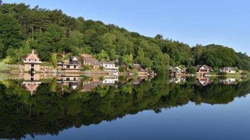 Landscape and buildings reflected in water