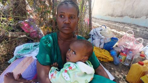 An Ethiopian woman who fled the ongoing fighting in Tigray region holds a child in Hamdait village on the Sudan-Ethiopia border in eastern Kassala state, Sudan November 14, 2020